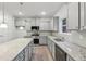 Kitchen featuring granite countertops, stainless appliances and gray cabinets at 3725 Heron Creek Ct, Loganville, GA 30052