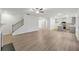 Open living space with stairs, modern kitchen and dining area featuring wood-look floors at 3725 Heron Creek Ct, Loganville, GA 30052