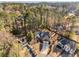 An aerial view of a well-maintained home with a two-car garage, surrounded by lush trees in a desirable neighborhood at 500 Huntgate Rd, Woodstock, GA 30189