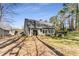 Expansive backyard showing home's sunroom addition and verdant landscaping at 500 Huntgate Rd, Woodstock, GA 30189