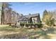 Expansive backyard featuring a well-maintained lawn and mature trees for serene outdoor enjoyment at 500 Huntgate Rd, Woodstock, GA 30189
