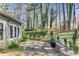 Lovely backyard with a stone patio and mature trees at 500 Huntgate Rd, Woodstock, GA 30189