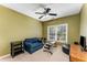 A bedroom with olive green walls, a ceiling fan, and workout equipment at 500 Huntgate Rd, Woodstock, GA 30189
