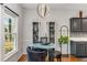 Modern kitchen and dining area featuring pendant lighting and wine storage at 500 Huntgate Rd, Woodstock, GA 30189
