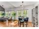 Bright dining area and living room with large windows overlooking the backyard at 500 Huntgate Rd, Woodstock, GA 30189