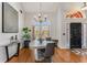 Formal dining area with chandelier, hardwood floors, and large window with lots of natural light at 500 Huntgate Rd, Woodstock, GA 30189