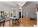 Open concept dining room with hardwood flooring, high ceilings, large windows and modern light fixtures at 500 Huntgate Rd, Woodstock, GA 30189