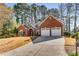 Charming brick home featuring a well-manicured lawn and two-car garage at 500 Huntgate Rd, Woodstock, GA 30189