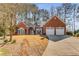 Beautiful brick home with well-manicured lawn and a two-car garage provides great curb appeal at 500 Huntgate Rd, Woodstock, GA 30189