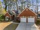 Attractive brick home with manicured landscaping, a two-car garage, and inviting curb appeal at 500 Huntgate Rd, Woodstock, GA 30189