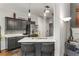 Kitchen featuring stainless appliances, gray cabinets, and marble backsplash at 500 Huntgate Rd, Woodstock, GA 30189