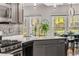 Well-lit kitchen featuring stainless steel appliances, grey cabinets, mosaic tile backsplash and hardwood floors at 500 Huntgate Rd, Woodstock, GA 30189