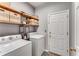 Efficient laundry room featuring shelving and front-load washer and dryer at 500 Huntgate Rd, Woodstock, GA 30189