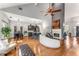Open-concept living room with hardwood floors, modern decor, a fireplace, and seamless flow to kitchen at 500 Huntgate Rd, Woodstock, GA 30189