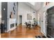 Open-concept living room with hardwood floors, fireplace, large windows, and stylish decor at 500 Huntgate Rd, Woodstock, GA 30189