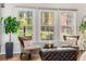 Bright living room with hardwood floors, large windows, and plush seating areas offers natural views at 500 Huntgate Rd, Woodstock, GA 30189