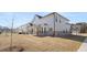 Rear of house view with brown grass and covered patio at 13573 Whitman Ln, Covington, GA 30014