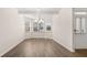 Bright dining room featuring a chandelier, tray ceiling, and a bay window at 13573 Whitman Ln, Covington, GA 30014