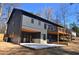 This home features a backyard with a patio, a wooden deck, and a modern gray exterior at 2078 Lyle Ave, College Park, GA 30337