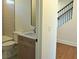 Bathroom featuring granite-topped vanity, tile accent wall and modern fixtures at 2078 Lyle Ave, College Park, GA 30337