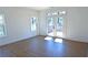 Bright bedroom with hardwood floors, white walls, and French doors to a balcony at 2078 Lyle Ave, College Park, GA 30337