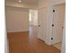 Bright hallway featuring wood-look floors, neutral walls, and white trim at 2078 Lyle Ave, College Park, GA 30337