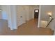 Hallway with hardwood floors featuring a staircase and front door at 2078 Lyle Ave, College Park, GA 30337