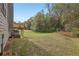Expansive backyard featuring a well-maintained lawn, mature trees, and a wooden deck at 4001 Oak Field Dr, Loganville, GA 30052