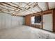 Unfinished basement with a door and window, offering potential for customization at 4001 Oak Field Dr, Loganville, GA 30052