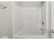 Bright, white bathroom featuring a shower-tub combination at 4001 Oak Field Dr, Loganville, GA 30052