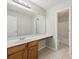 Bathroom with a long vanity, a large mirror, and tile flooring, plus a peek at the toilet and tub/shower at 4001 Oak Field Dr, Loganville, GA 30052