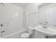Clean bathroom features a shower-tub combination and a pedestal sink with a large mirror at 4001 Oak Field Dr, Loganville, GA 30052