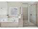 Bathroom featuring a shower, jacuzzi tub, and large windows at 4001 Oak Field Dr, Loganville, GA 30052