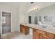 Bright bathroom with double sinks, tiled floors, and shower near a door at 4001 Oak Field Dr, Loganville, GA 30052