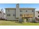 Back exterior of a two-story home featuring a wooden deck and well-kept backyard at 4001 Oak Field Dr, Loganville, GA 30052