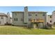 Back exterior of a two-story home featuring a wooden deck and well-kept backyard at 4001 Oak Field Dr, Loganville, GA 30052