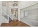 Bright foyer with hardwood floors, staircase, and view to the living room at 4001 Oak Field Dr, Loganville, GA 30052
