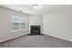 Room with fireplace and neutral walls receiving natural light from window at 4001 Oak Field Dr, Loganville, GA 30052