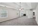 Open living space with cozy fireplace, two windows, and neutral walls at 4001 Oak Field Dr, Loganville, GA 30052