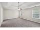 Spacious primary bedroom featuring a tray ceiling and plush carpeting at 4001 Oak Field Dr, Loganville, GA 30052