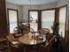 Cozy breakfast nook with wicker furniture, bright windows, and unique lighting fixture at 1040 Rolling Green Dr, Acworth, GA 30102