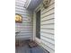 View of back entrance door with glass window, wood siding, and patio at 1040 Rolling Green Dr, Acworth, GA 30102
