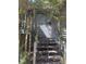 Staircase leading to glass front door with wood siding and foliage at 1040 Rolling Green Dr, Acworth, GA 30102