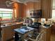Kitchen with wood cabinets, stainless steel microwave, and stained glass window at 1040 Rolling Green Dr, Acworth, GA 30102