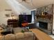 Living room featuring a stone fireplace, high ceiling, and comfortable seating at 1040 Rolling Green Dr, Acworth, GA 30102