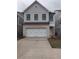 Charming two-story home with a brick-and-wood exterior and a white garage door at 1071 Crest Mill Dr, Marietta, GA 30008