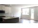 Bright kitchen with a center island, stainless steel appliances, and a door leading to the backyard at 1071 Crest Mill Dr, Marietta, GA 30008