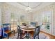 Sunlit breakfast nook features a charming table and chairs with a view of the yard at 2135 Primrose Place Ln, Lawrenceville, GA 30044