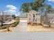 Brick home with a spacious driveway and manicured front yard under a clear, sunny sky at 2135 Primrose Place Ln, Lawrenceville, GA 30044