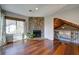 Cozy living area features a stone fireplace, a window, and hardwood floors, offering a warm and inviting space at 2249 Chimney Springs Dr, Marietta, GA 30062